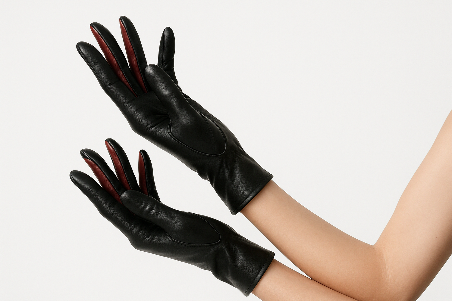 A lady wearing leather gloves, u only see a sideshot of both hands portrayed elegantly with a white background, you only see arms, a bit of skin and then the gloves, make sure the insides of the fingers are red leather and the rest is black leather.